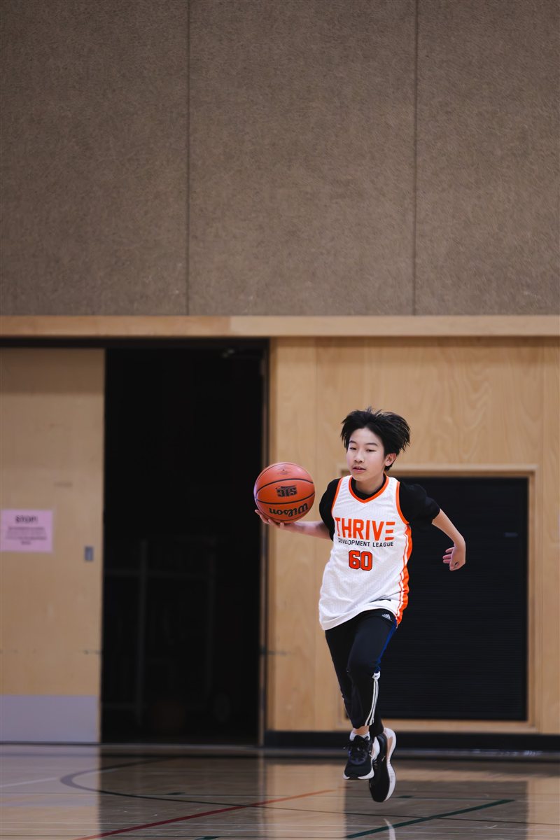 Basketball player bringing the ball up the court