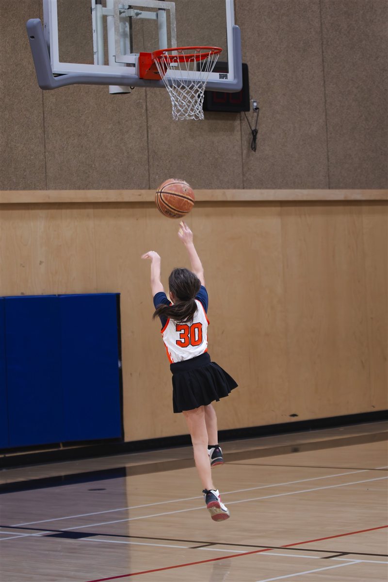Basketball player taking a shot toward the basket
